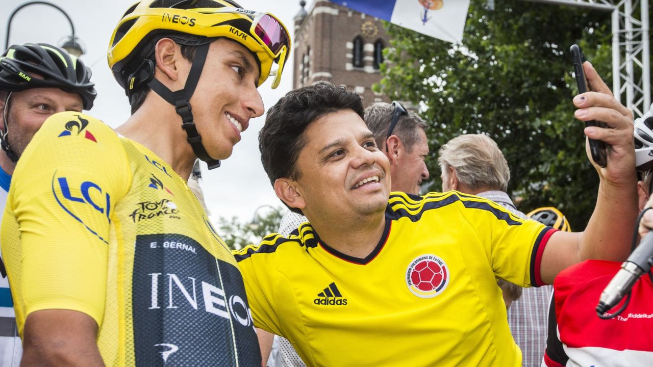 Colombia's Tour de France winner Egan Bernal (L) poses for a 'selfie' with a supporter from Colombia ahead of the start of the Acht van Chaam criterium cycling race in Chaam on July 31, 2019.