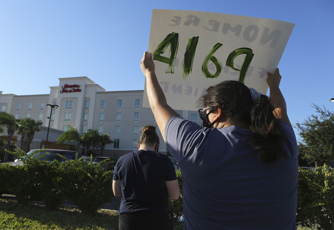 Protesters wave signs in front of the Hampton Inn hotel in McAllen, Texas, on July 23rd.