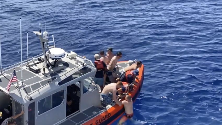 A US Coast Guard crew scrambled to get out of the water when a 6ft-8ft shark was spotted heading their way while they swam in Oceania.