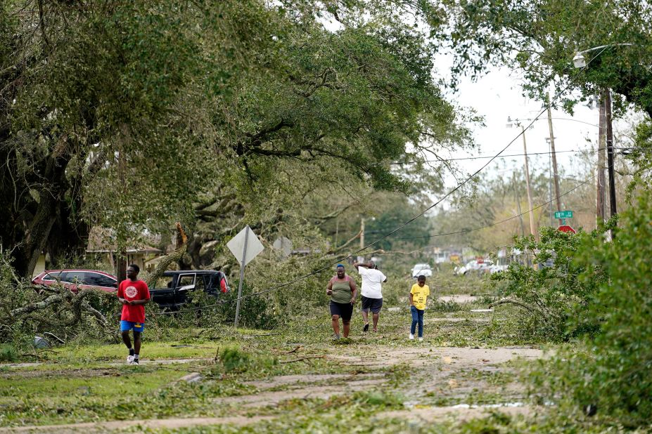 People survey the damage to their Lake Charles neighborhood on August 27.
