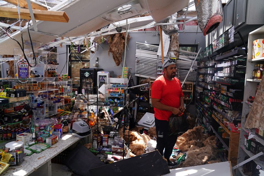 Ahmed Nawaz looks at the damage in his store in Lake Charles on August 27.