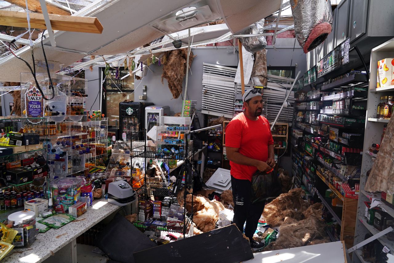 Ahmed Nawaz looks at the damage in his store in Lake Charles on August 27.