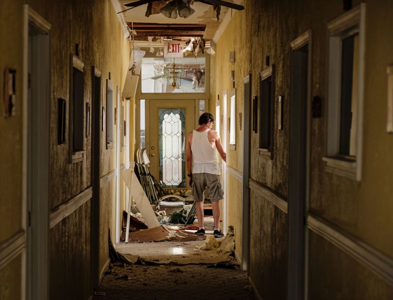 A man walks through a debris-filled hallway on the second floor of a Lake Charles church that lost its roof on August 27.