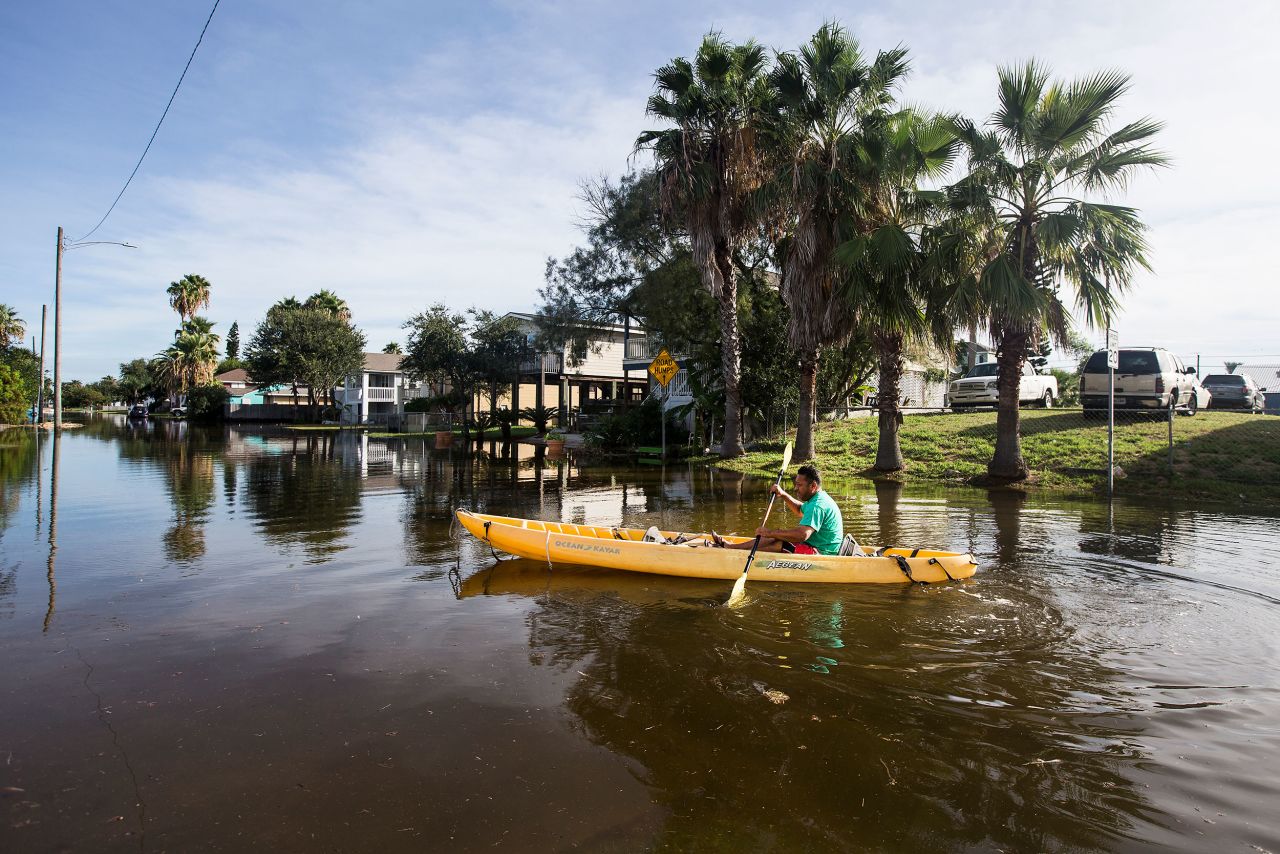 Martin Almanza paddles a canoe through a flooded section of Galveston, Texas, on August 27.