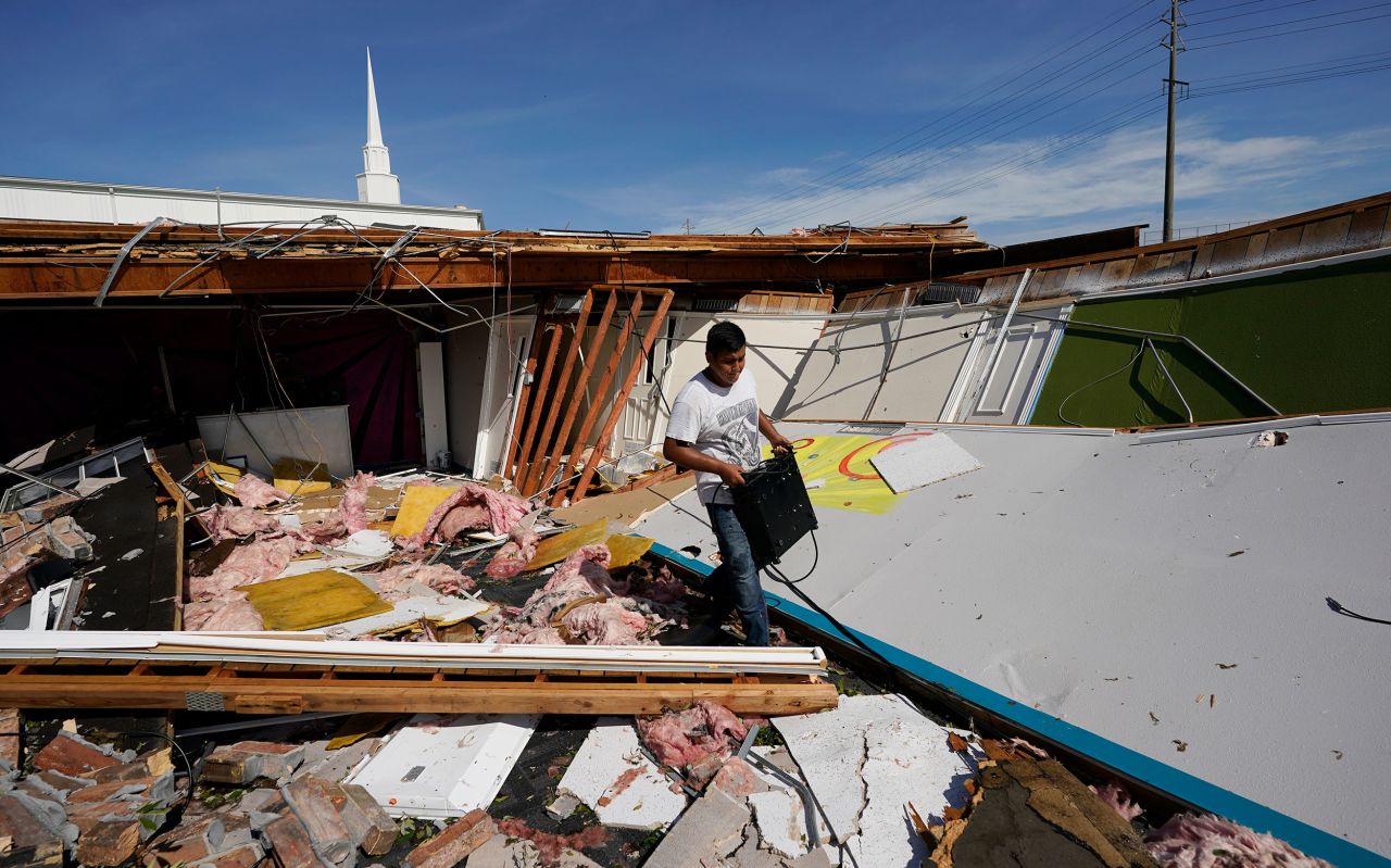 Benjamin Luna helps recover items from the children's wing of the First Pentecostal Church in Orange, Texas, on August 27.