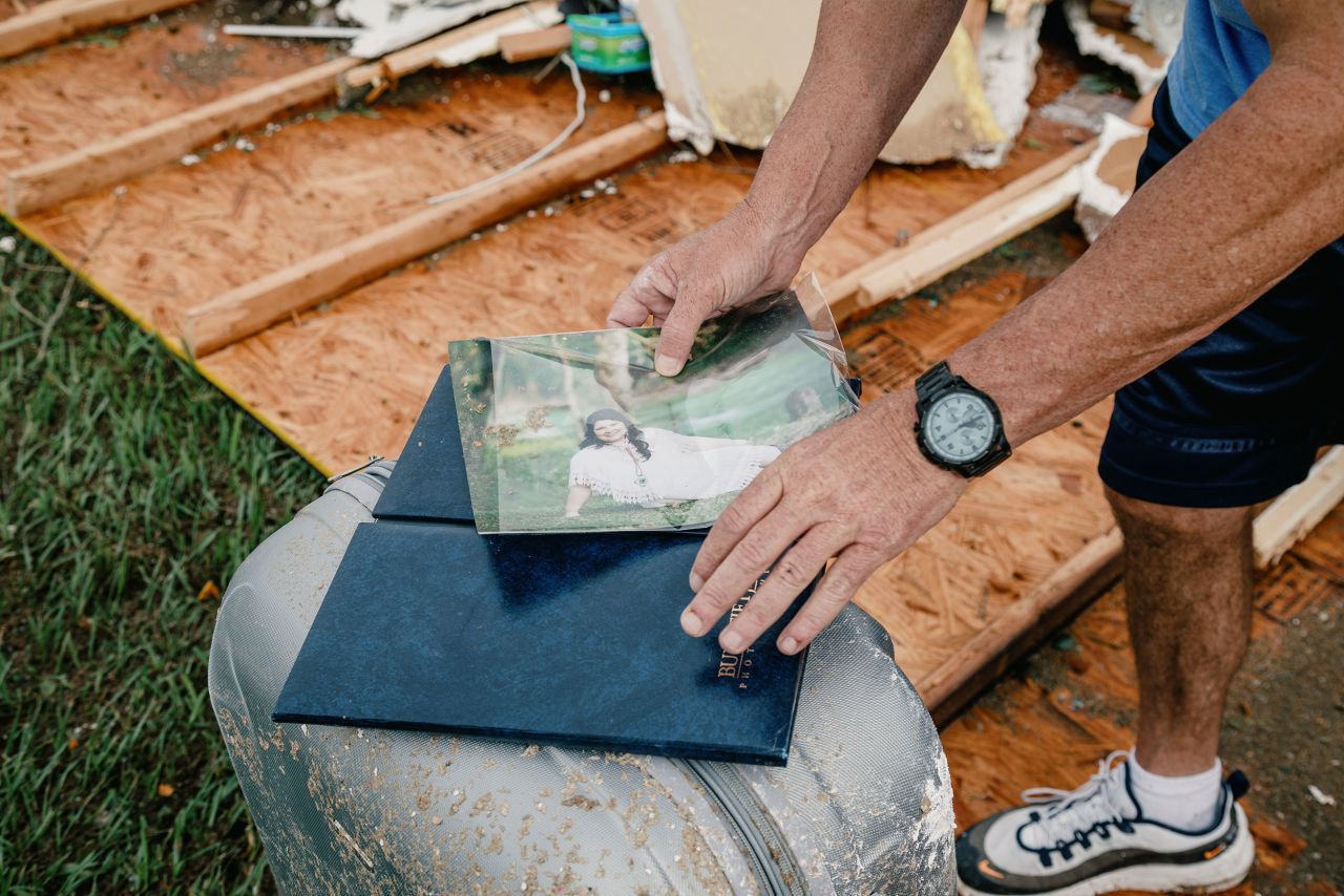 A person holds a photo taken from a damaged home in Cameron Parish, Louisiana, on August 27.