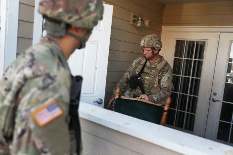 Louisiana National Guard Pfc. Devin Lejeune helps search a Lake Charles apartment complex for people in need.