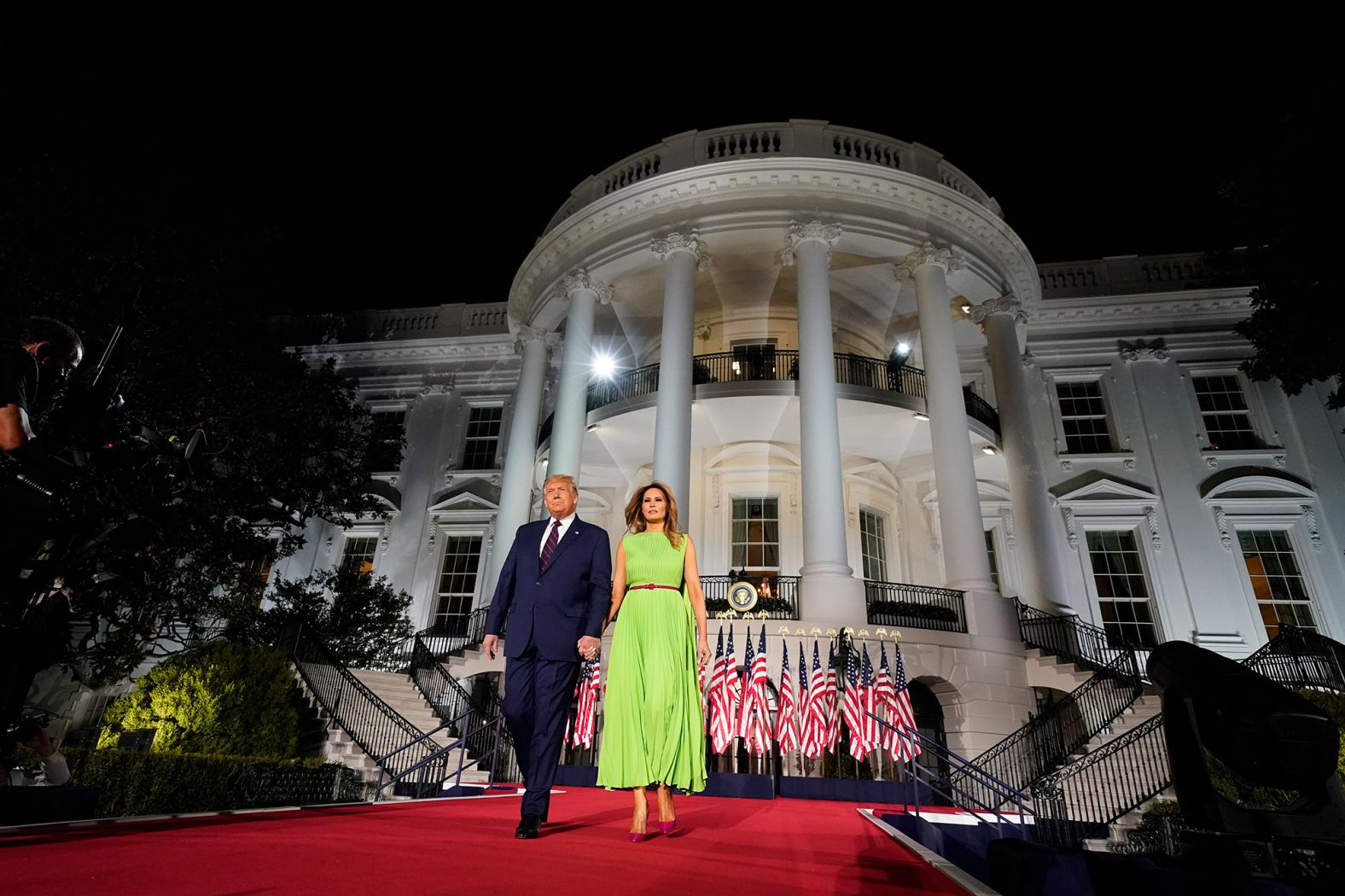 The President is accompanied by the first lady as he arrives for his speech on Thursday.