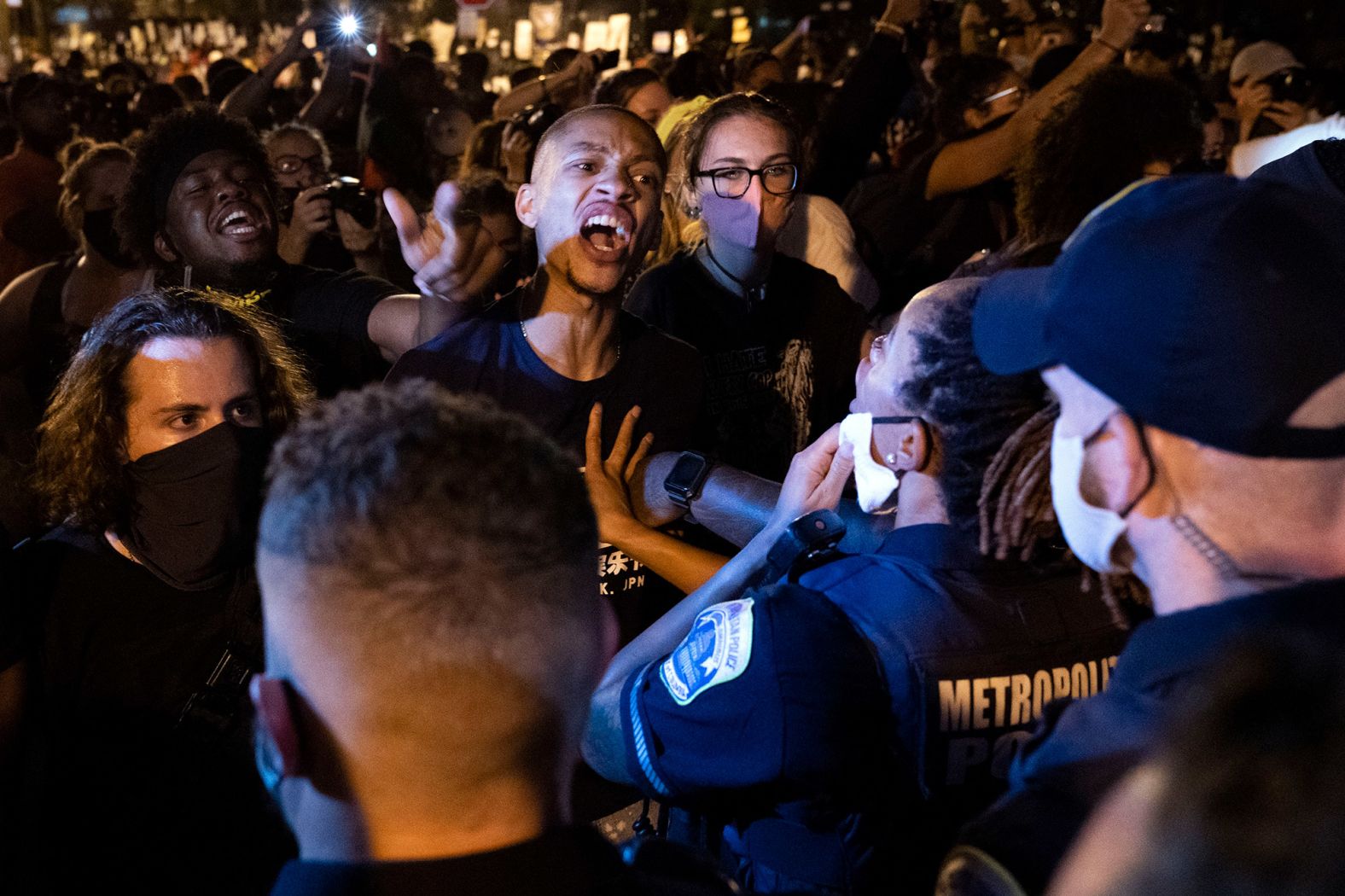 Demonstrators confront police officers during a rally outside the White House on Thursday.
