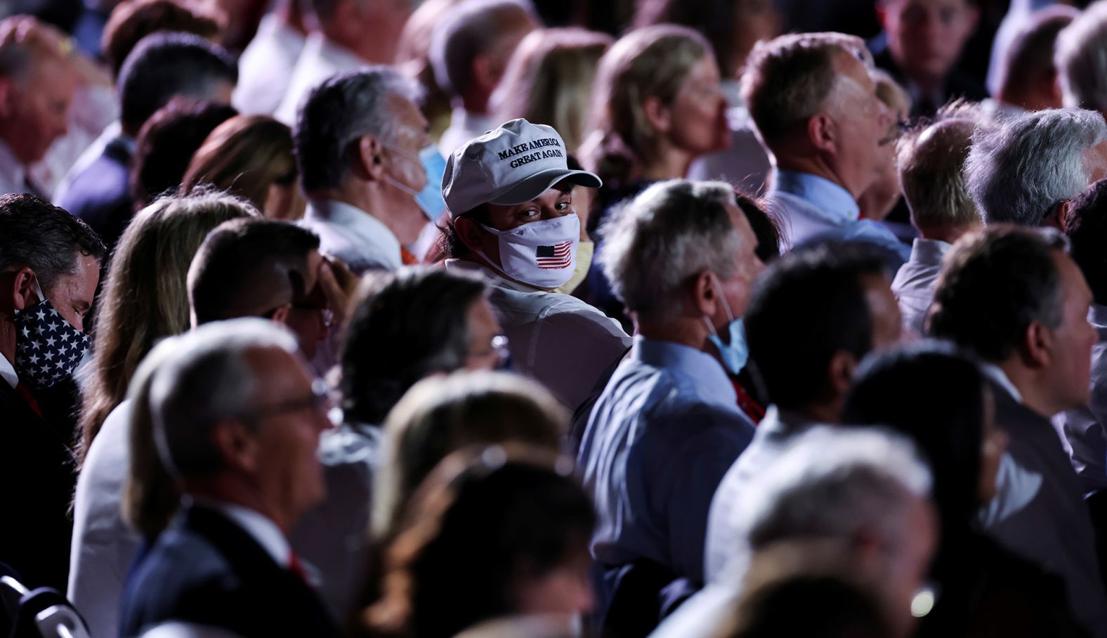 People watch Trump deliver his speech at the White House.