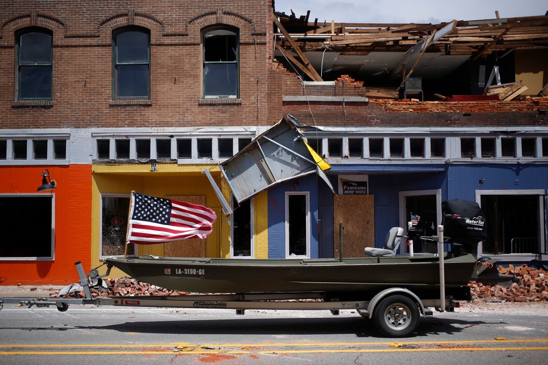 A US flag flies Thursday on a boat parked in front of a damaged building after Hurricane Laura made landfall in Lake Charles.