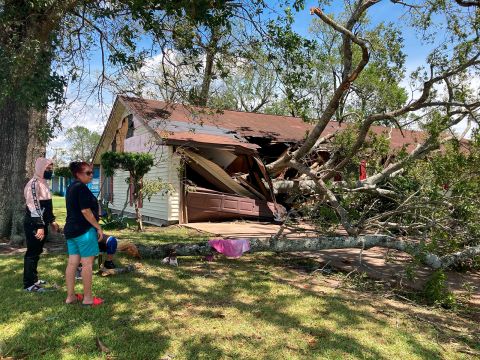 Maria Ramirez and her 17-year-old son, Jose Avila, survey the damage to their home in Orange, Texas, on August 27.