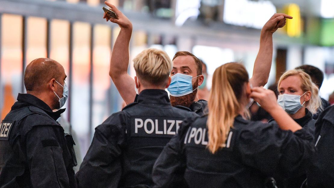 Police enforce the wearing of mandatory face masks at the train station in Essen, Germany on Monday, August 24.