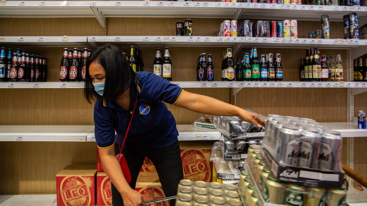  An employee restocks cases of beer at a supermarket the night before a citywide alcohol ban on April 9 in Bangkok, Thailand. 