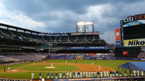 The Mets and Marlins stand in a moment of silence prior to the start of the game at Citi Field in New York City on Thursday.