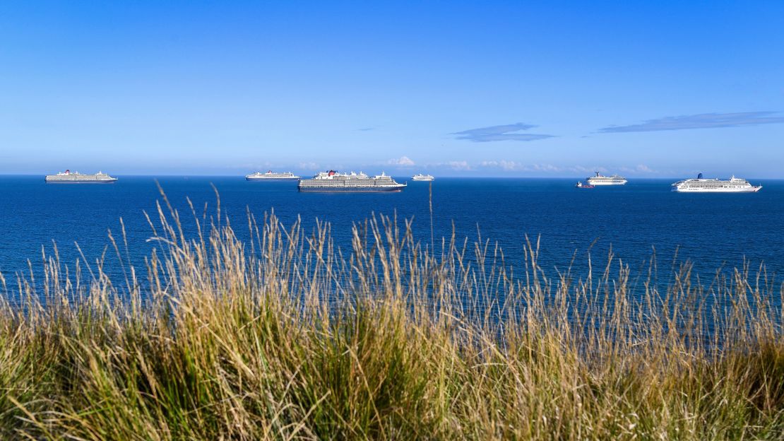 Cruise ships parked off the coast of southwest England.