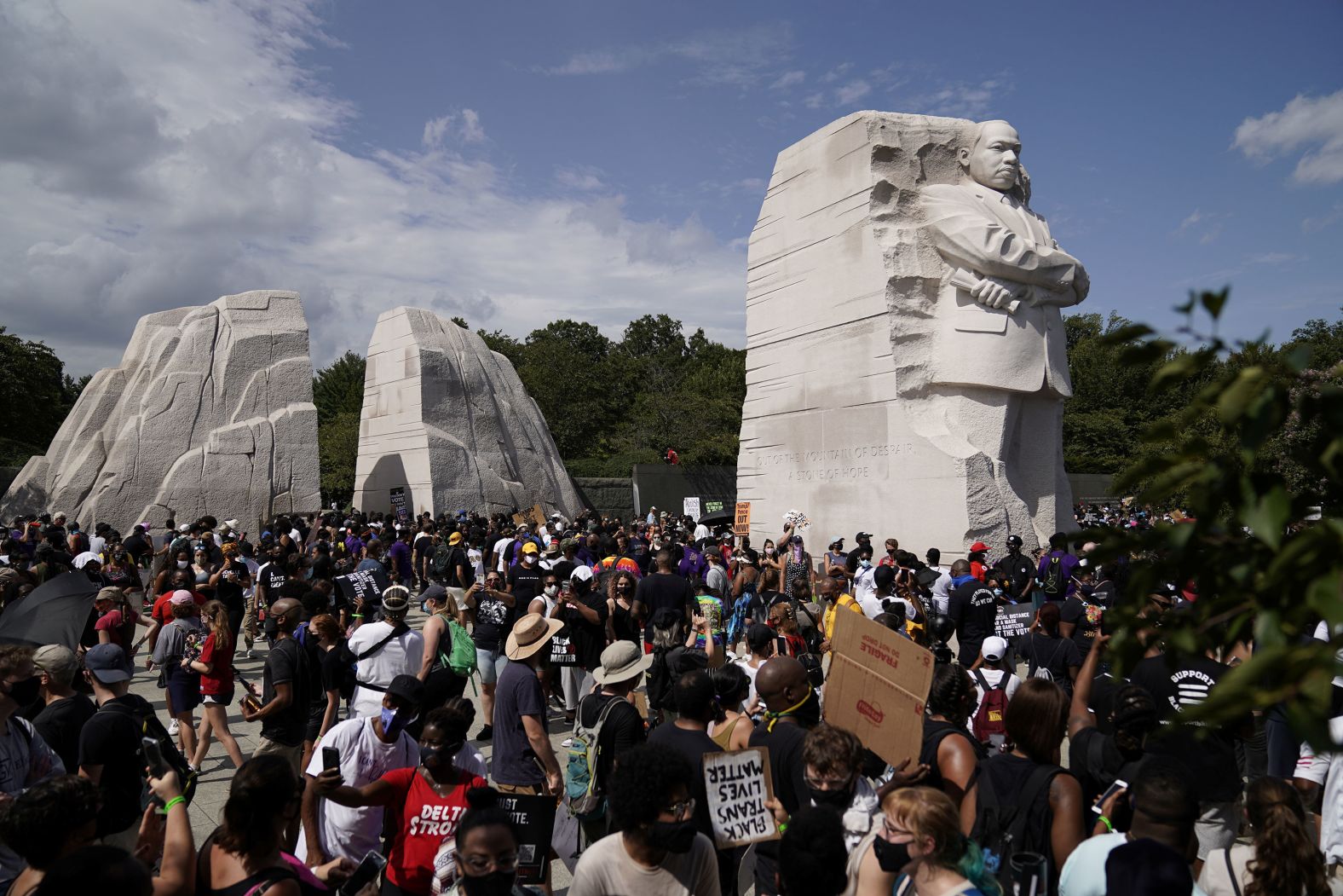 Demonstrators gather next to the Martin Luther King Jr. Memorial after marching from the Lincoln Memorial.