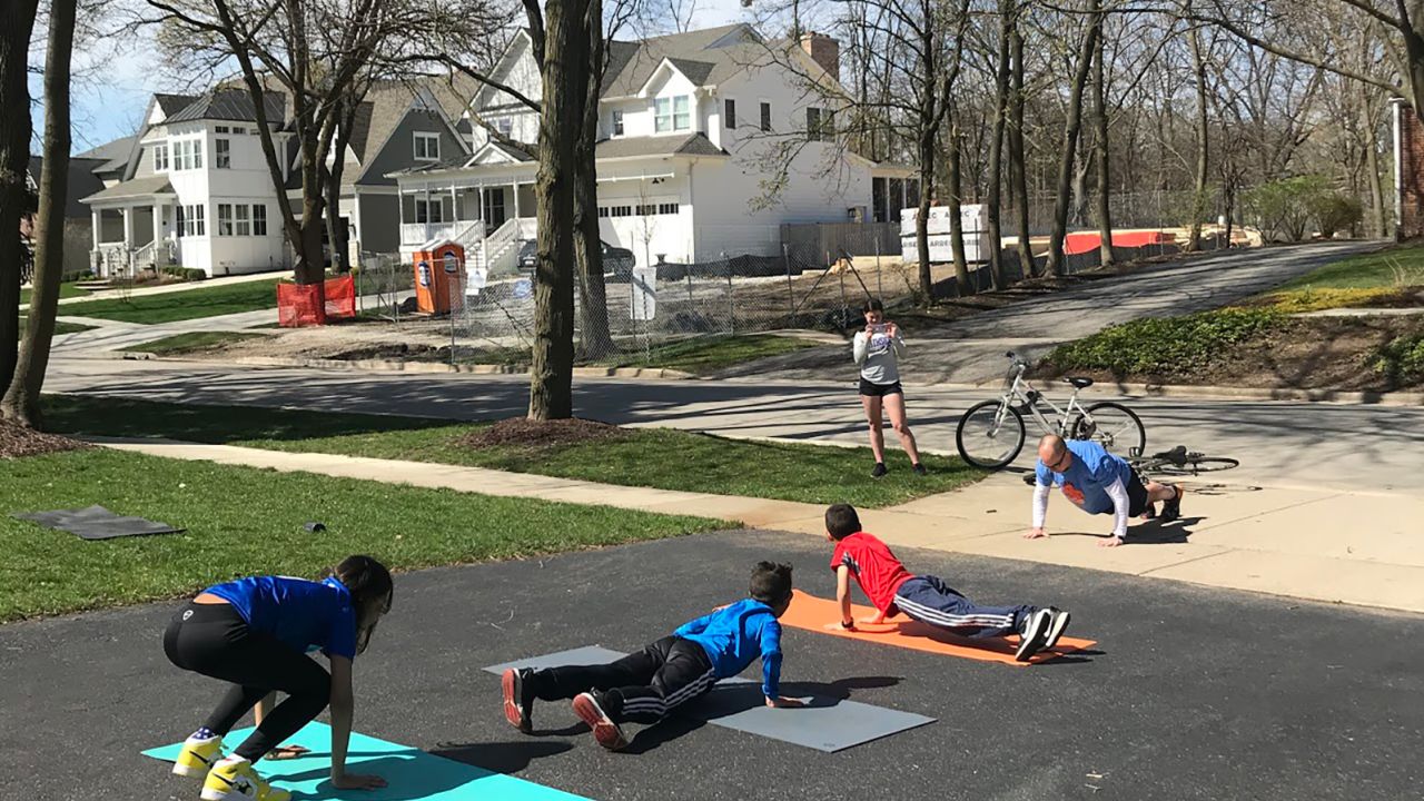 Joe Schallmoser (far right), athletic director at Avery Coonley School in Downers Grove, Ill., traveled to his students' homes to do burpees in their driveways while social distancing.