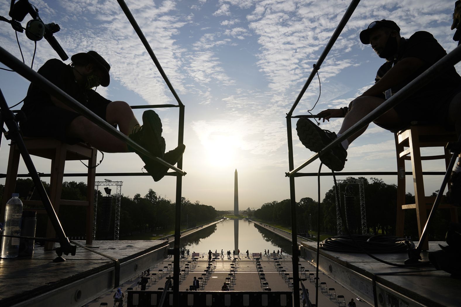 The early morning sun rises over the Washington Monument and the Lincoln Memorial's Reflecting Pool as final preparations are made for the March on Washington. 