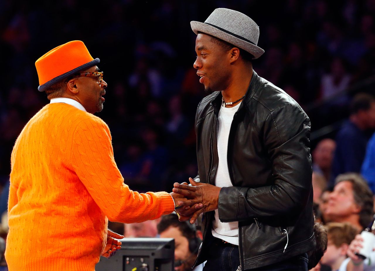 Boseman greets film director Spike Lee at an NBA game in New York in 2013.