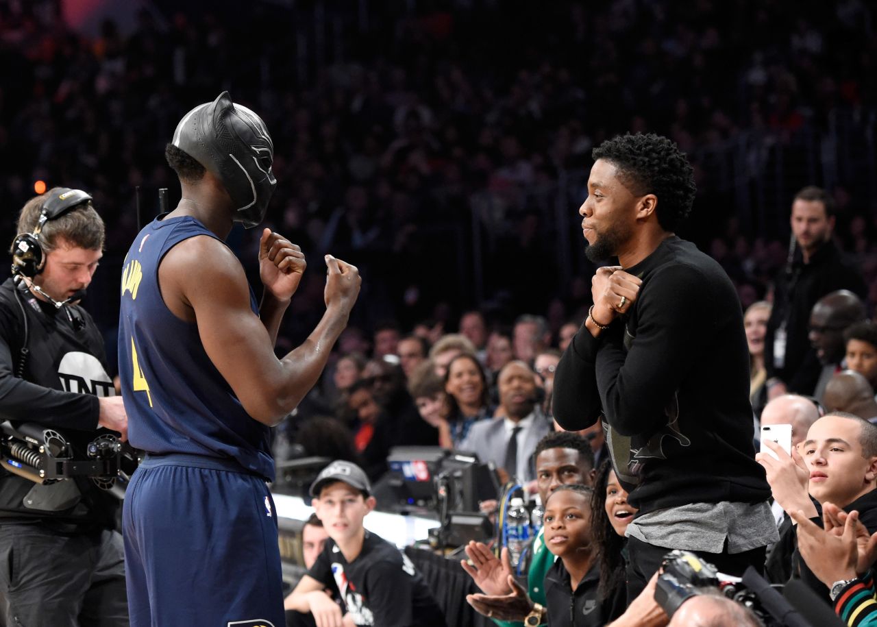While competing in the 2018 NBA Dunk Contest, Victor Oladipo wears a Black Panther mask and does the "Wakanda Forever" salute with Boseman, who was sitting courtside.