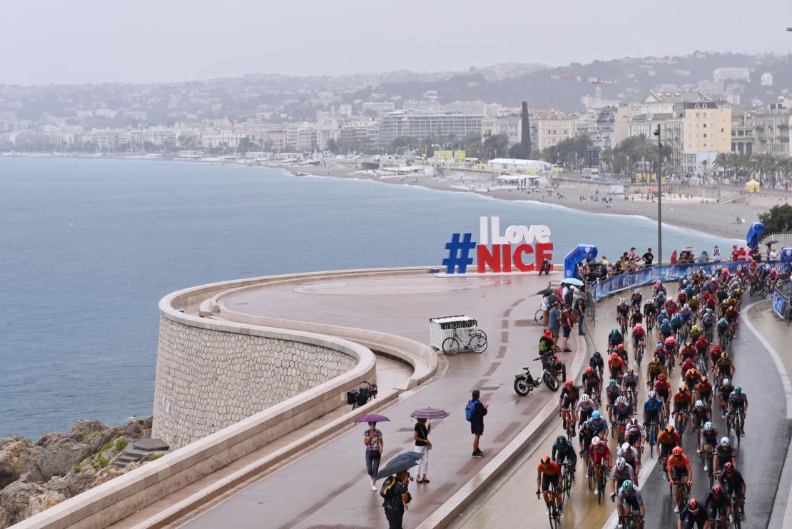 The Tour de France peloton competes on rain soaked roads in Nice at the start of the 107th Tour de France on a stage littered with crashes in treacherous conditions.