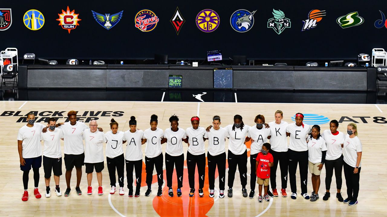 The Washington Mystics each wear white T-shirts with seven bullets on the back protesting the shooting of Jacob Blake by Kenosha, Wisconsin, police.