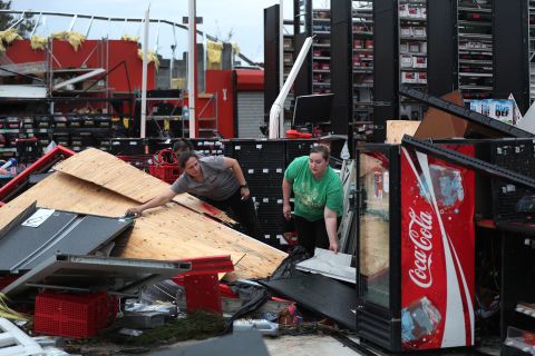 Rachel Ellis, left, and J'Nay Fitch salvage items from the AutoZone store where they work in Lake Charles on August 28.