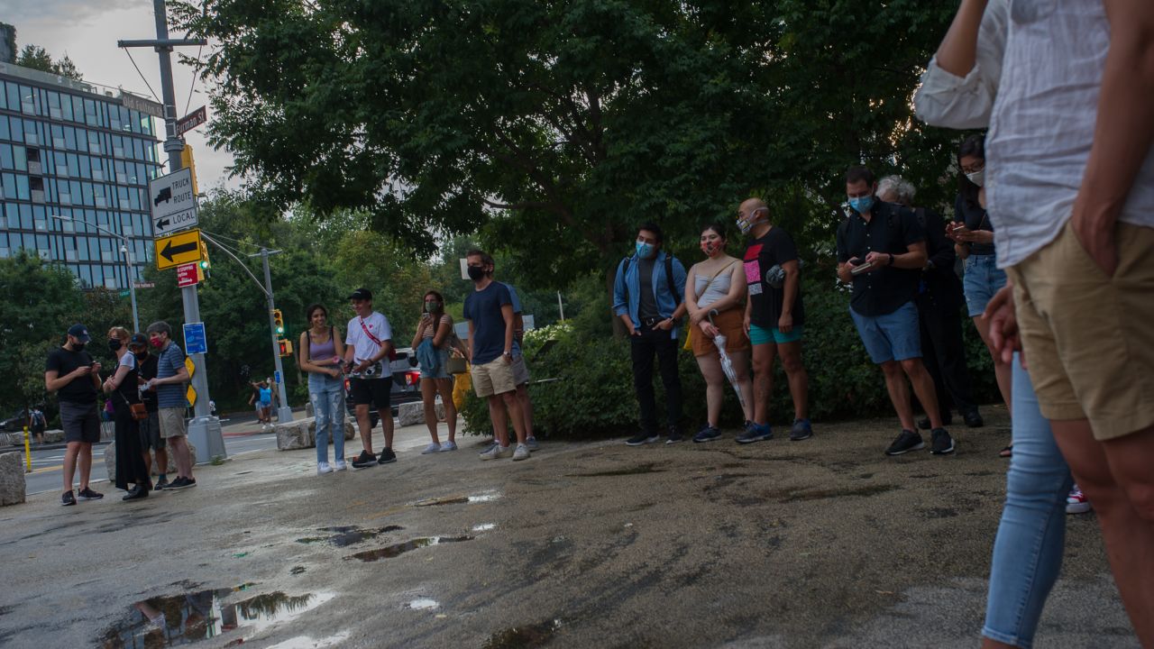 A crowd gathers at Friday's Philharmonic performance in Brooklyn Bridge Park. Performances are kept short to minimize crowd size and promote social distancing.