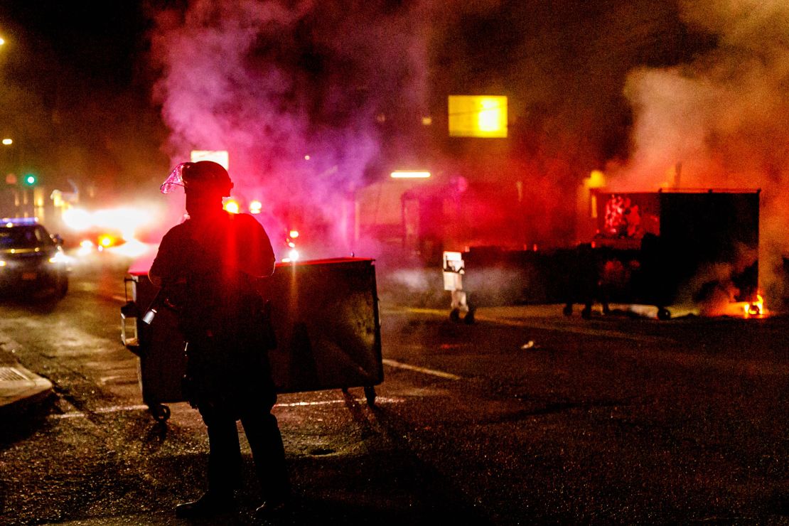 People protesting police brutality spray graffiti and start fires at the Portland Police Union on Friday. 