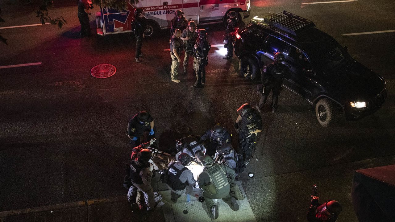 Aaron J. Danielson is treated by medics after being shot during a confrontation on Saturday, Aug. 29, 2020, in Portland, Oregon.