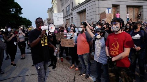 People gather Tuesday, August 25 to protest in Kenosha, Wisconsin. Anger over the Sunday shooting of Jacob Blake, a Black man, by police spilled into the streets for a third night. 