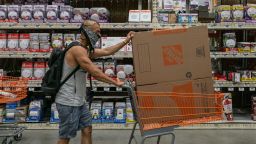 A shopper wearing a protective mask pushes a cart at a Home Depot Inc. store in Jersey City, New Jersey, U.S., on Friday, Aug. 14, 2020. Home Depot is scheduled to release earnings figures on August 18. Photographer: Jeenah Moon/Bloomberg via Getty Images