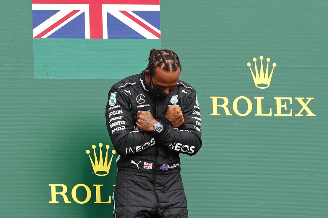 Lewis Hamilton adopts a Black Panther gesture on the podium of the Belgian Grand Prix in tribute to actor Chadwick Boseman. 