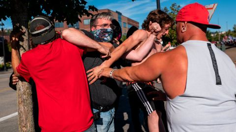 A Black Lives Matter protester scuffles with attendees of a pro-Trump rally during an event held to show support for the president on Saturday in Clackamas, Oregon.