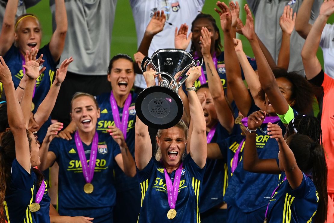 Midfielder Amandine Henry raises the Champions League trophy.
