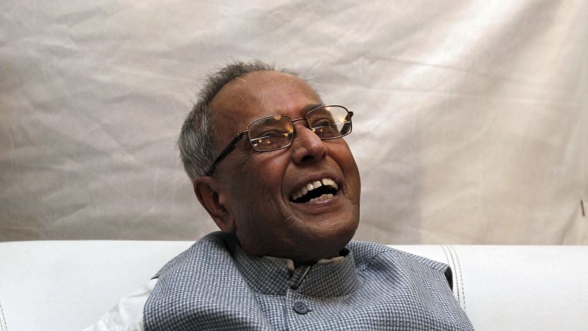 India's former Finance Minister Pranab Mukherjee, who resigned in June to run for president, shares a moment as he interacts with media at his residence in New Delhi July 10, 2012. REUTERS/Adnan Abidi (INDIA - Tags: POLITICS)
