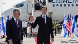 US Presidential Adviser Jared Kushner waves as he stands next to National Security Adviser Robert O'Brien prior to boarding the historic first commercial flight from Israel to the United Arab Emirates.