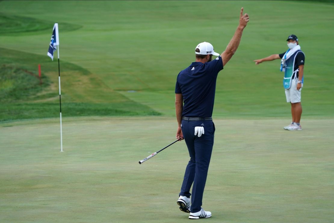 Johnson celebrates making his putt for birdie on the 18th hole to force a playoff at the BMW Championship. 