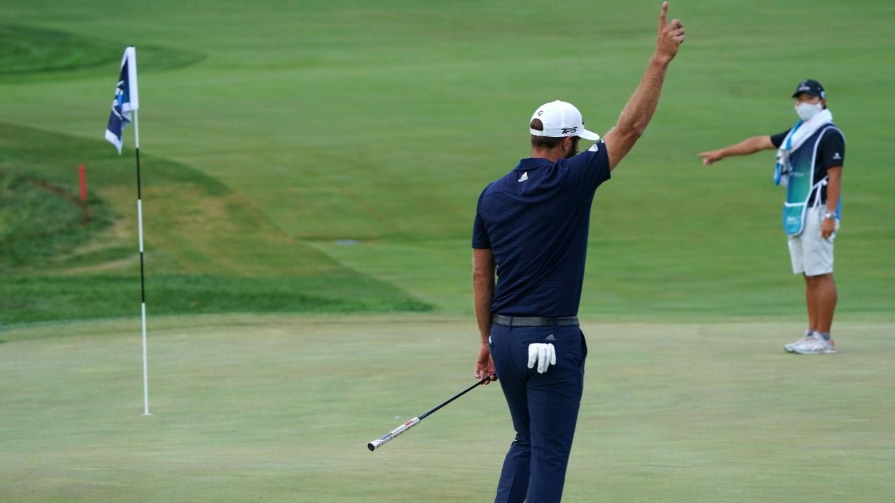 Johnson celebrates making his putt for birdie on the 18th hole to force a playoff at the BMW Championship.