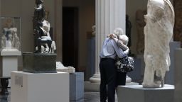 NEW YORK, NY - AUGUST 27: People wearing face masks hug with each other at The Metropolitan Museum of Art as it reopens to members after the pandemic closure, on August 27, 2020 in New York City, NY. (Photo by Liao Pan/China News Service via Getty Images)