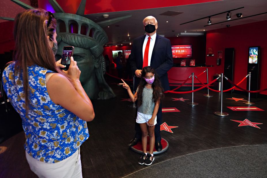 A child is photographed in front of a Donald Trump wax figure at Madame Tussauds New York on August 27. 