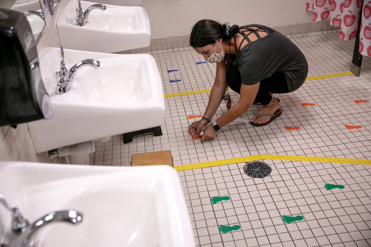 A preschool teacher in Stamford, Connecticut, prepares a student bathroom August 26 for the upcoming semester.