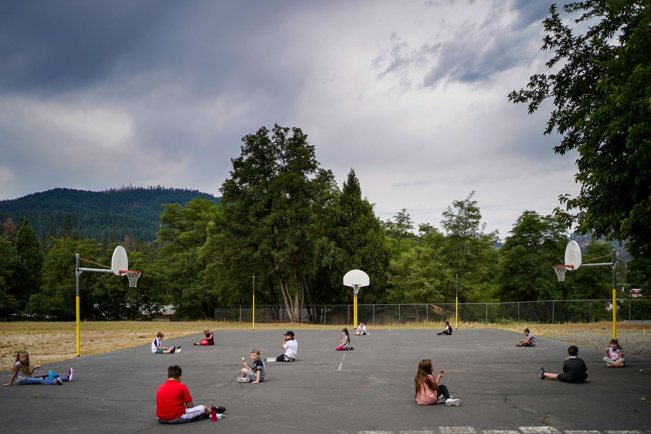 Second-grade teacher Darsi Green's class practices social distancing while eating lunch on a basketball court in Weaverville, California, on August 17.