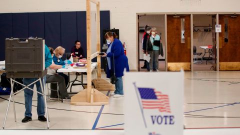 A woman checks in to cast her ballot during a Democratic presidential primary election at the Kenosha Bible Church gym in Kenosha, Wisconsin, on April 7, 2020. 