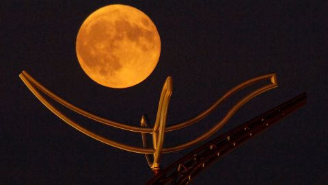 A full "corn moon" rises above a large metal sculpture on the campus of the University of Minnesota, Duluth. 