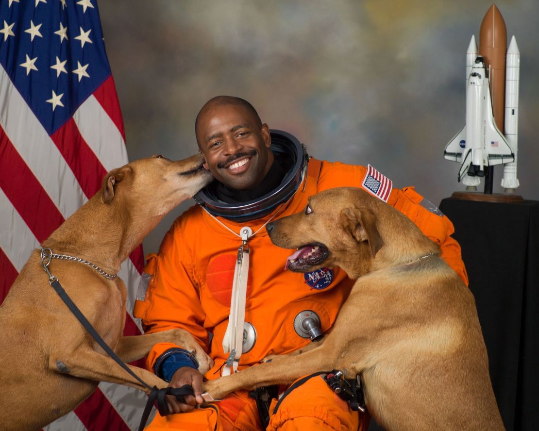 Melvin's now-famous NASA portrait features his two rescue dogs, Jake and Scout, who he secretly smuggled into NASA for the photo shoot.