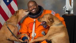 Leland Melvin's now-famous NASA portrait featuring his two rescue dogs, Jake and Scout, who he secretly smuggled into NASA for the photoshoot.