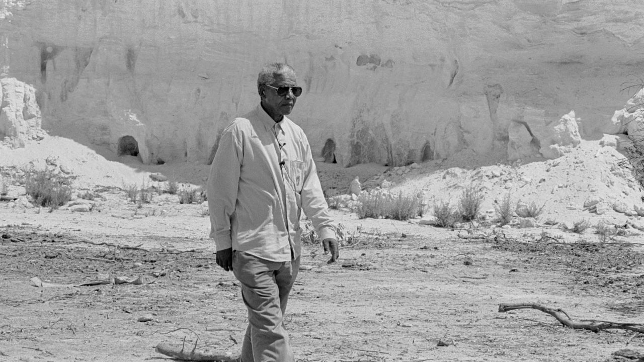 A portrait of Mandela in 1995. Mandela returns to the lime quarry in 1994, where he was assigned to work while imprisoned.