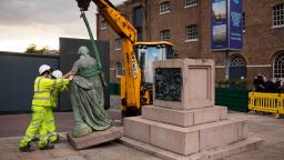 Mandatory Credit: Photo by Shutterstock (10674954e)
The statue of Robert Milligan is lifted from its plinth using a JCB in front of the Museum of London Docklands West India Docks near Canary Wharf.
The statue of Robert Milligan is removed by workers, West India Quay, London., London, UK - 09 Jun 2020